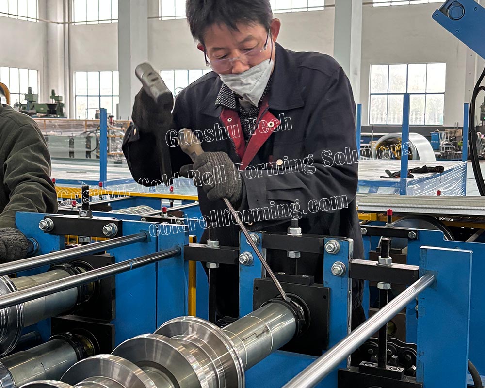 worker-adjusting-roller-gap-gutter-machine.jpg